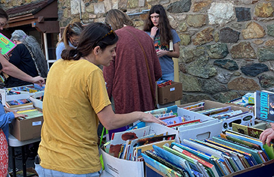 A woman shopping at the 2024 Purcellville Library Advisory Board book sale.